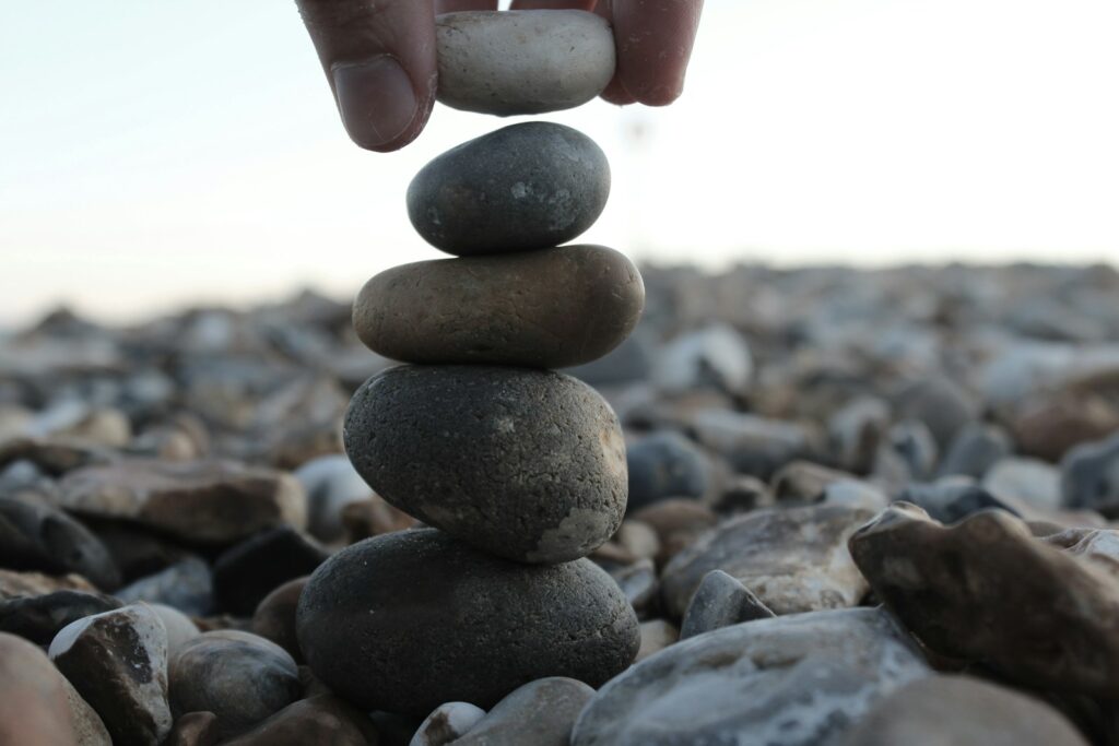 a person stacking rocks on top of each other